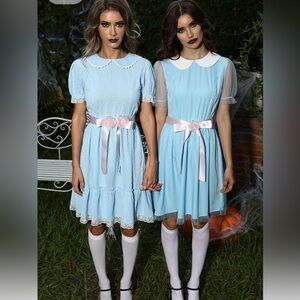 A pair of blue creepy twin Halloween costumes.